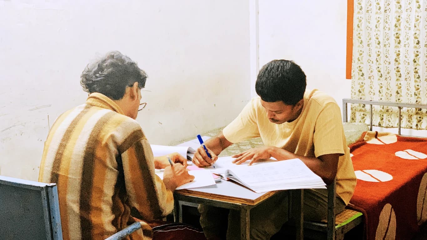 Students Studying Collaboratively in Hostel Room